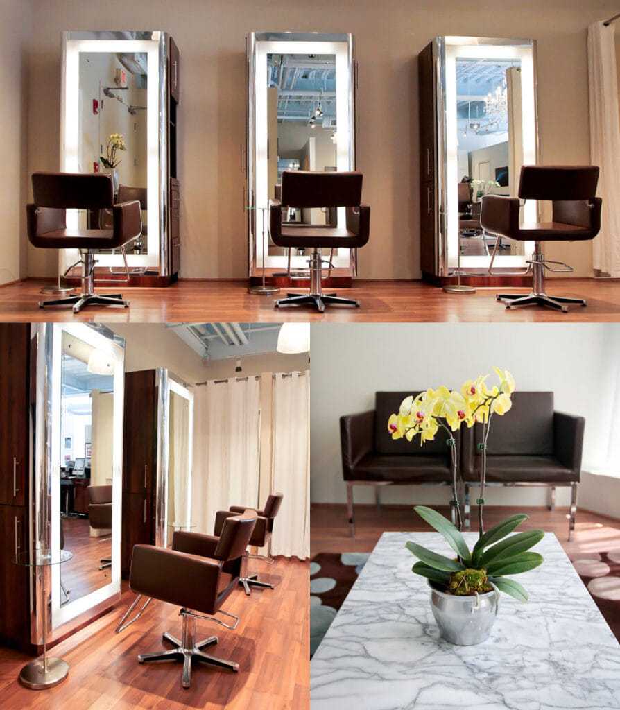 Modern salon with styling stations, marble table, orchid, and seating area.